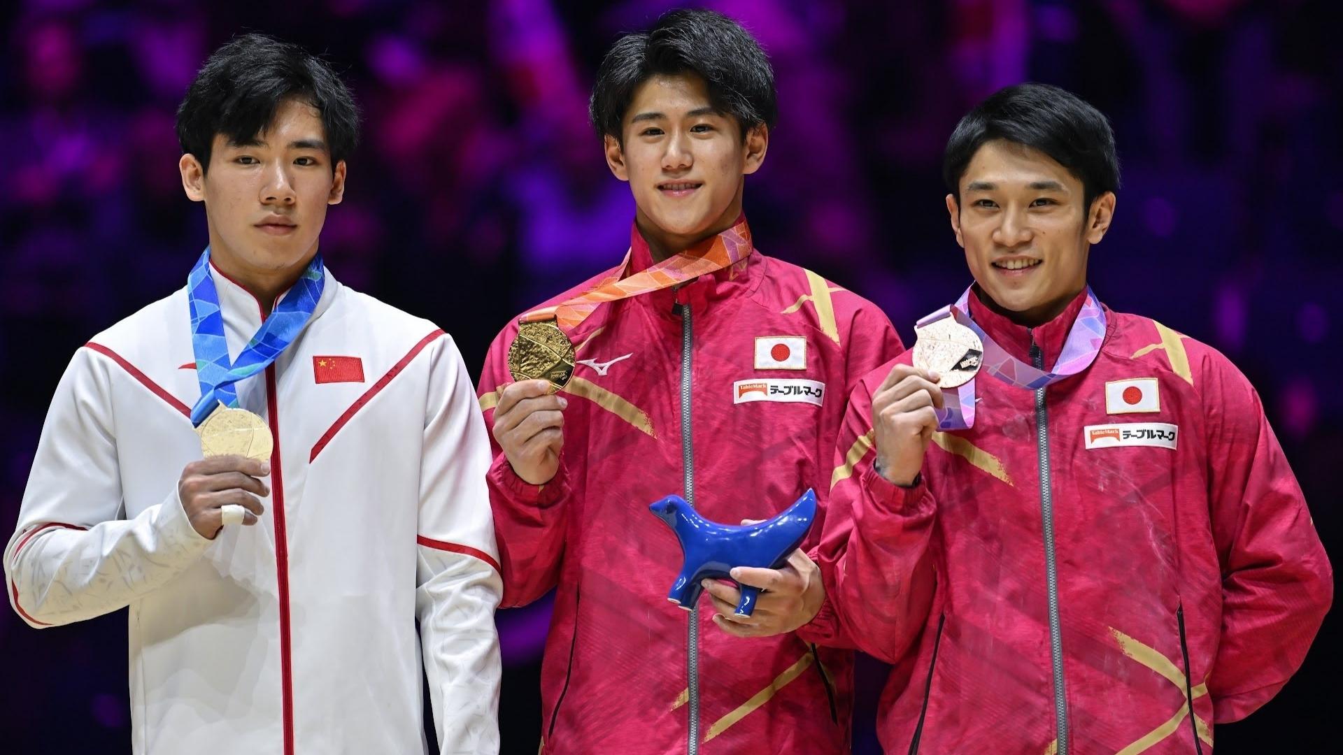 Japan's Daiki Hashimoto (center) won gold in the men's all-around on Friday at the 2022 World Gymnastics Championships. China's Boheng Zhang (left) and Japan's Wataru Tanigawa (right) won silver and bronze, respectively.