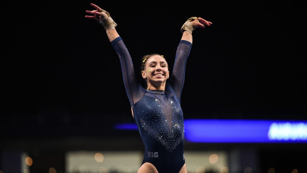Michigan's Natalie Wojcik salutes after competing on floor during the semifinals of the 2022 NCAA Women's Gymnastics Championships.