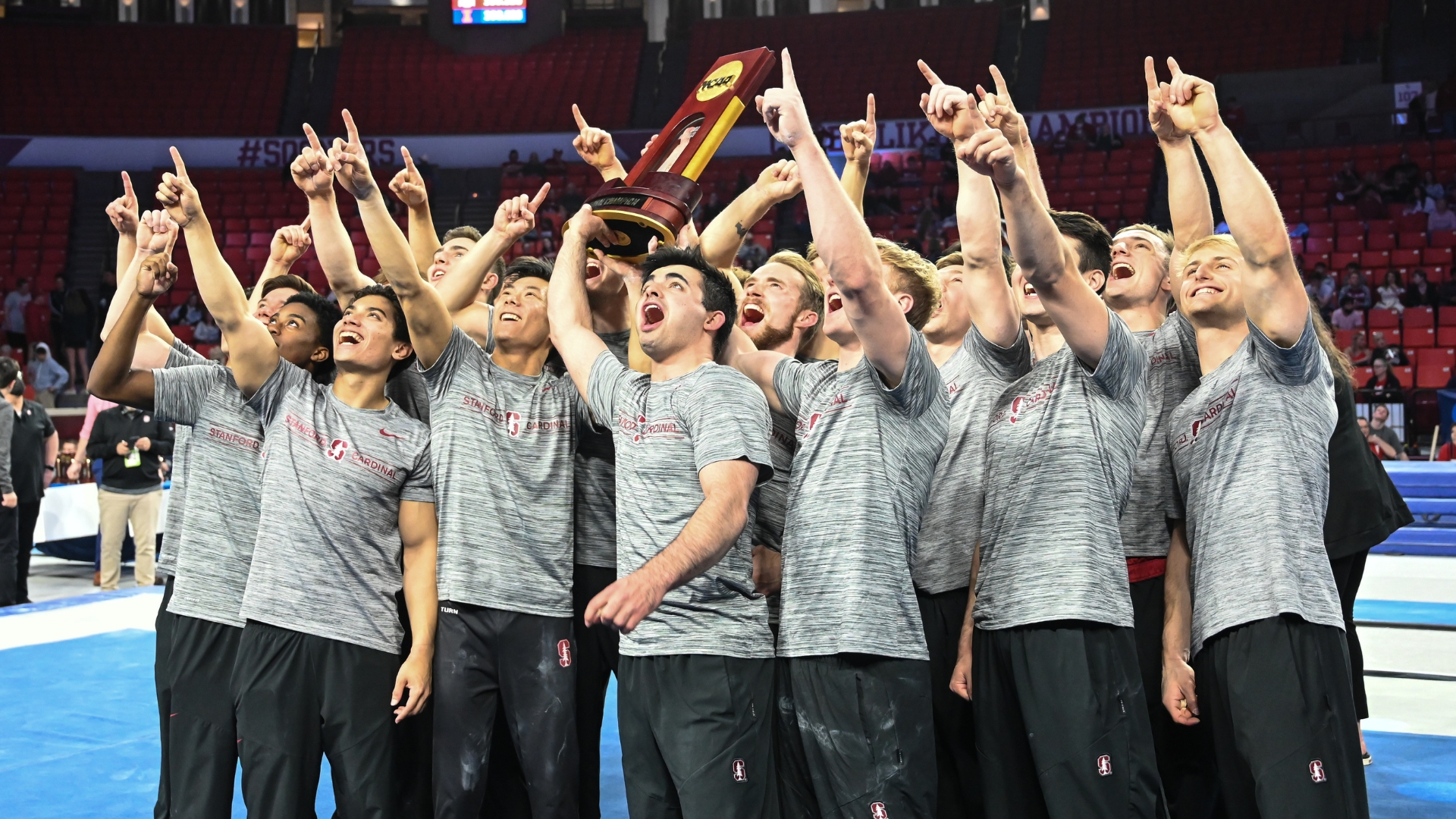 2022 Stanford men's gymnastics team holds national title trophy after winning