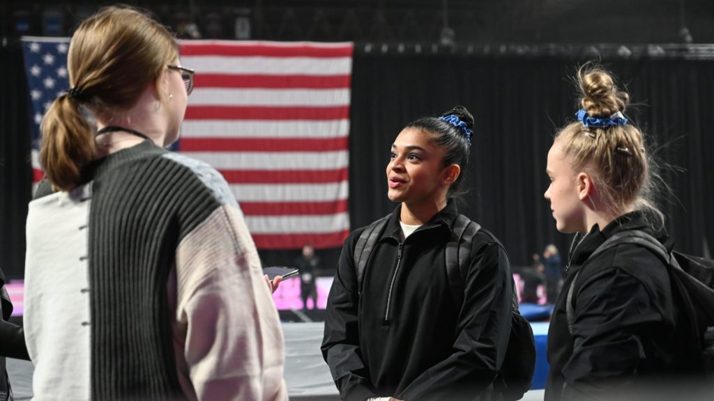 Tiana Sumanasekera (middle) and Joscelyn Roberson (right) talk with Gymnastics Now founder and editor Patricia Duffy (left) after 2023 Winter Cup podium training on Feb. 24.
