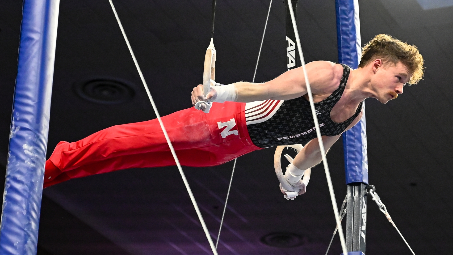Nebraska's Liam Doherty-Herwitz competes on rings during the semifinals of the 2022 NCAA Men's Gymnastics Championships.