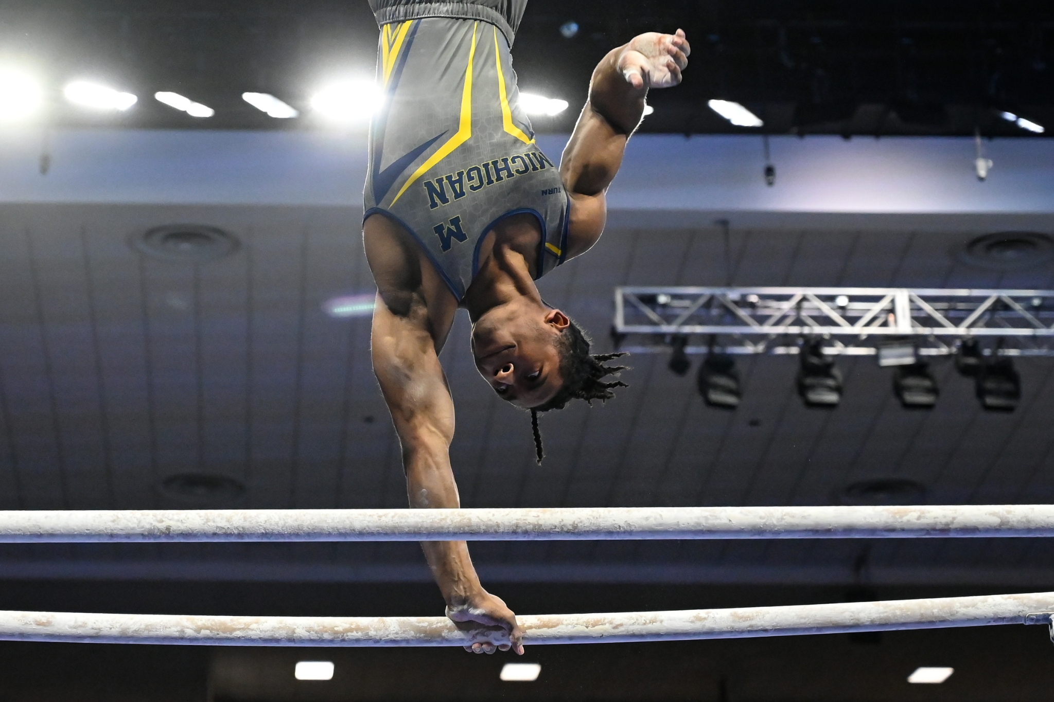 Michigan's Virgil Watkins swings parallel bars during the 2022 NCAA Men's Gymnastics Championships semifinals.