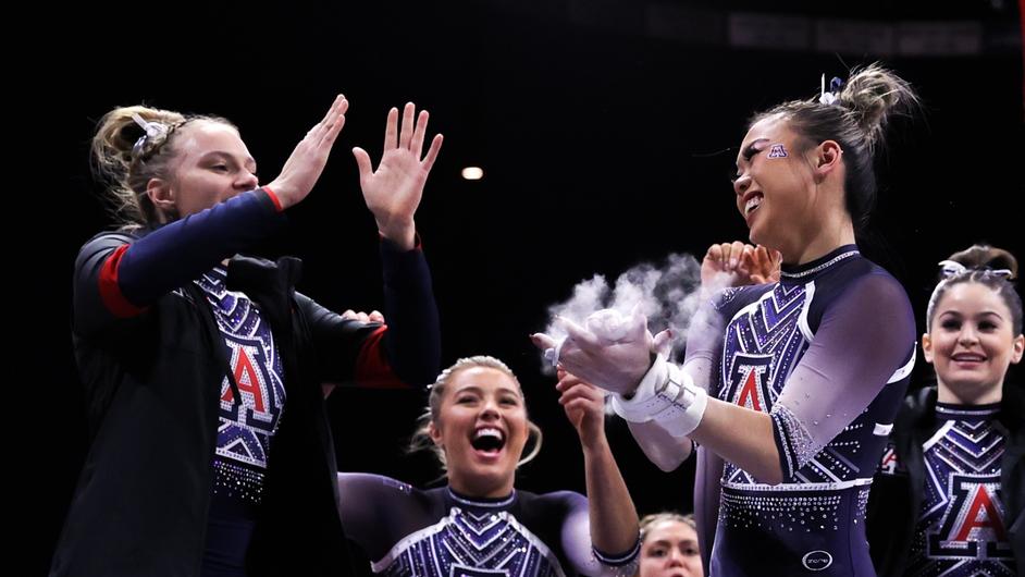 Arizona gymnastics athletes celebrate.