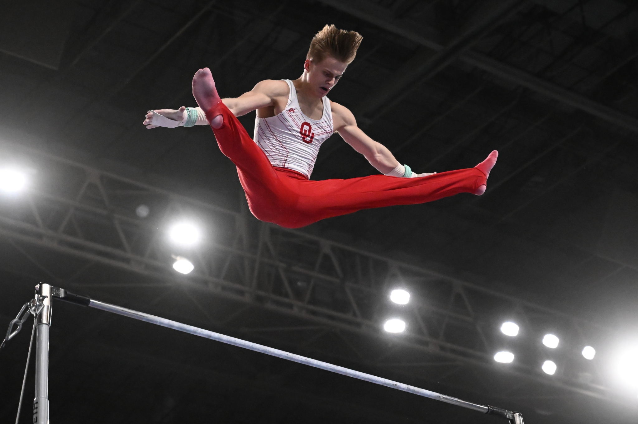 Oklahoma's Jack Freeman performs a straddled Tkatchev on high bar at the 2023 Winter Cup.
