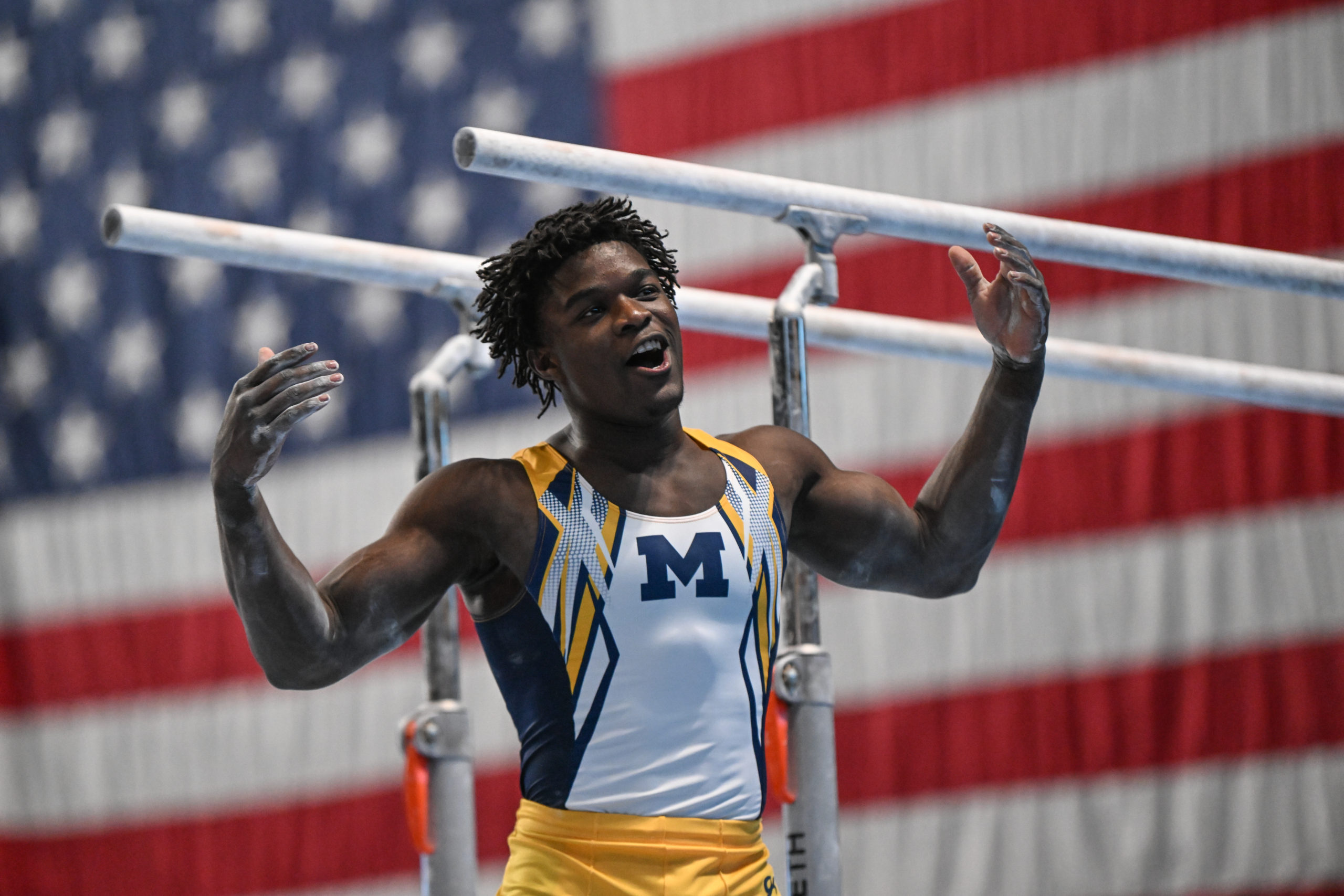 Michigan's Fred Richard reacts after dismounting parallel bars during the 2023 Winter Cup.