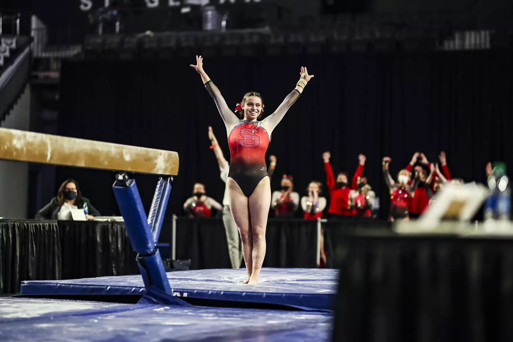 NC State's Chloe Negrete salutes after dismounting balance beam.