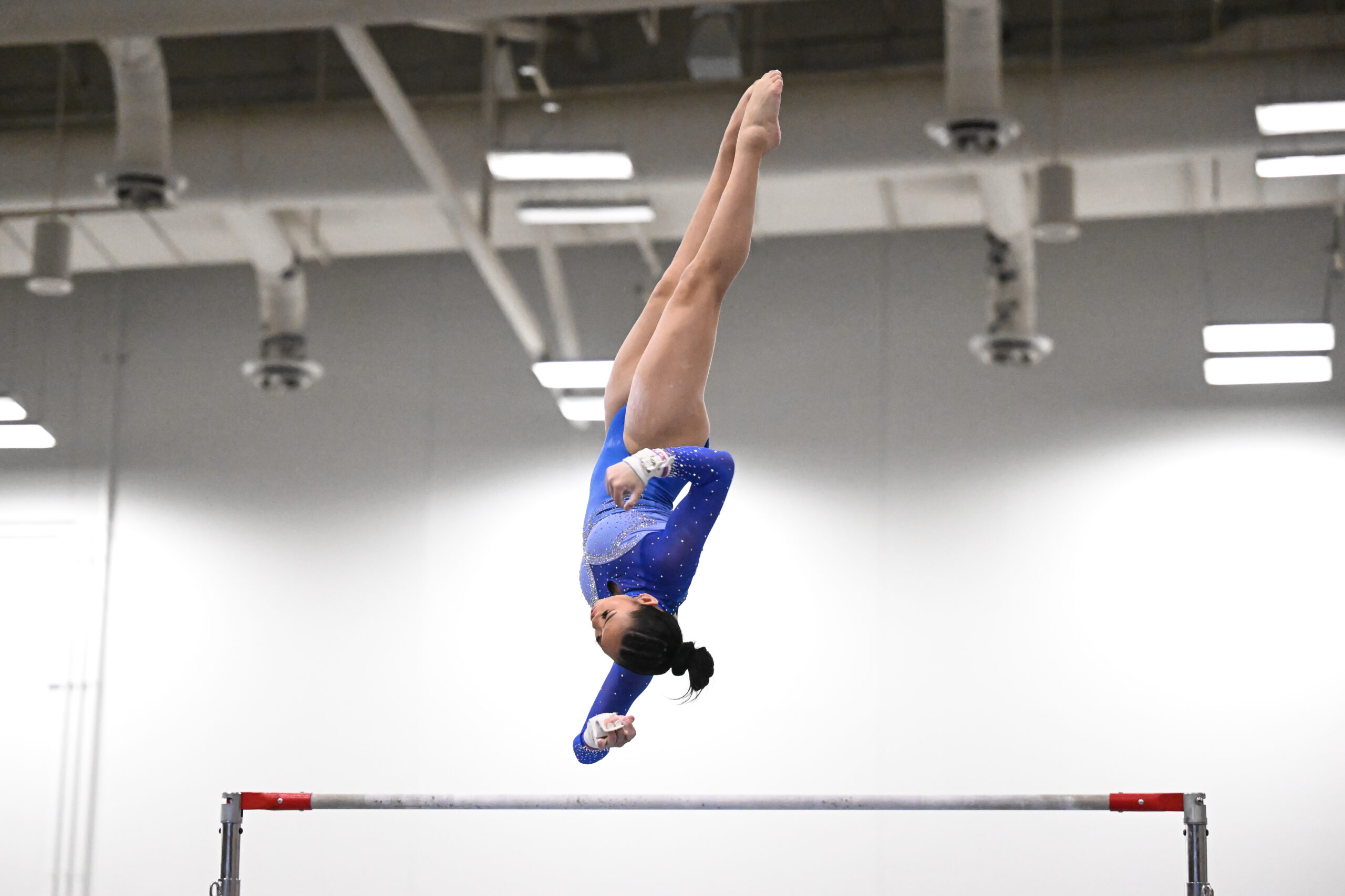 Sunisa Lee on bars, performing her new skill – the full-twisting, laid-out Jaeger – during warmups at the 2024 Winter Cup.