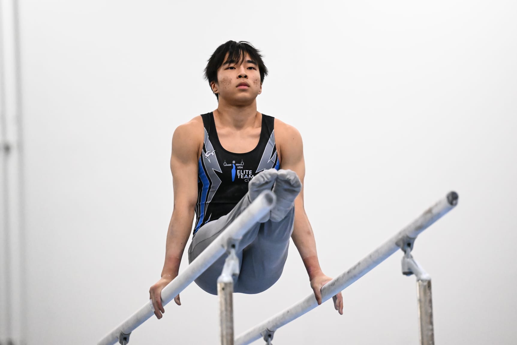 Region 3's Jun Iwai on parallel bars during the 2024 Elite Team Cup.