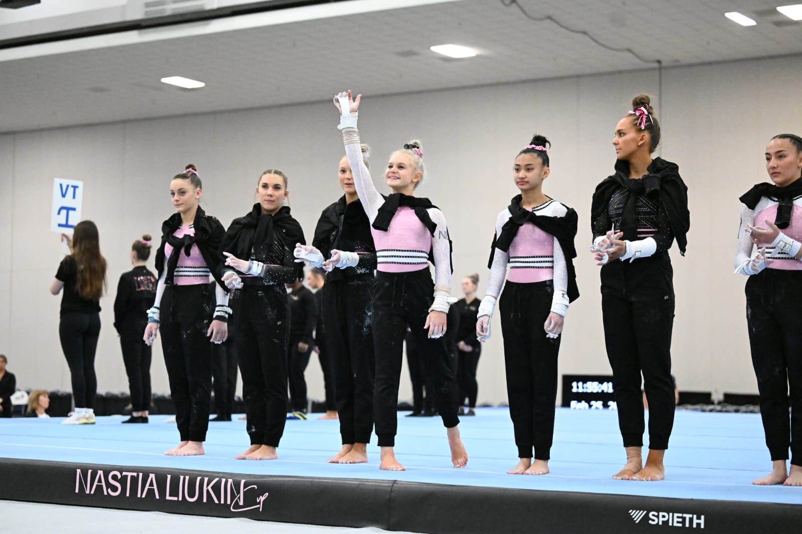 Ella Kate Parker waves during march in at the 2024 Nastia Liukin Cup.