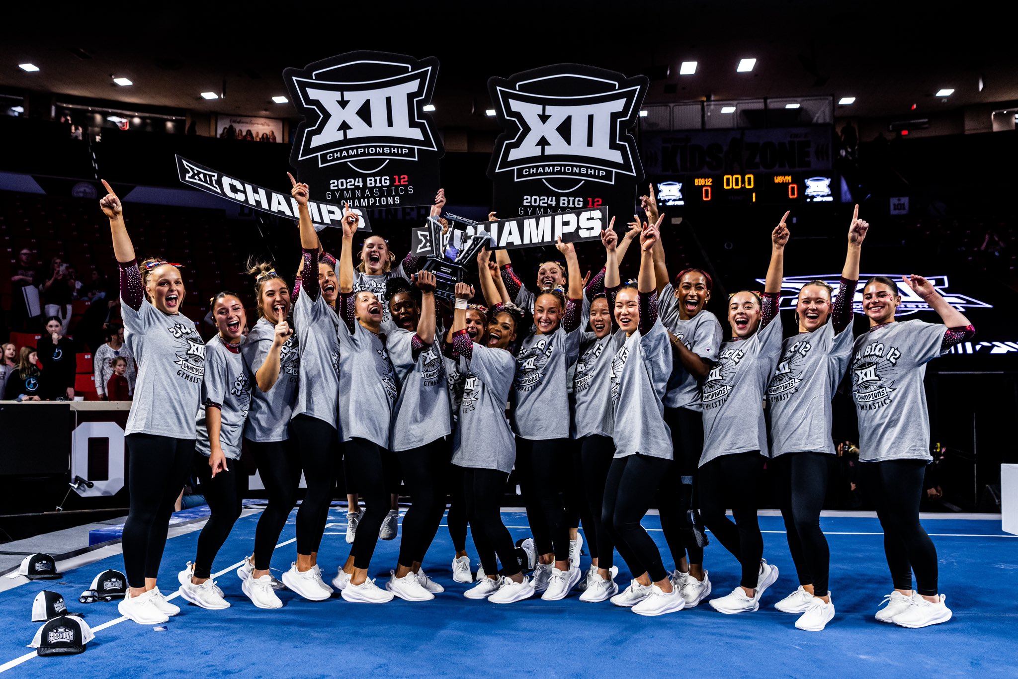 The Oklahoma women's gymnastics team celebrates winning the 2024 Big 12 Gymnastics Championship.