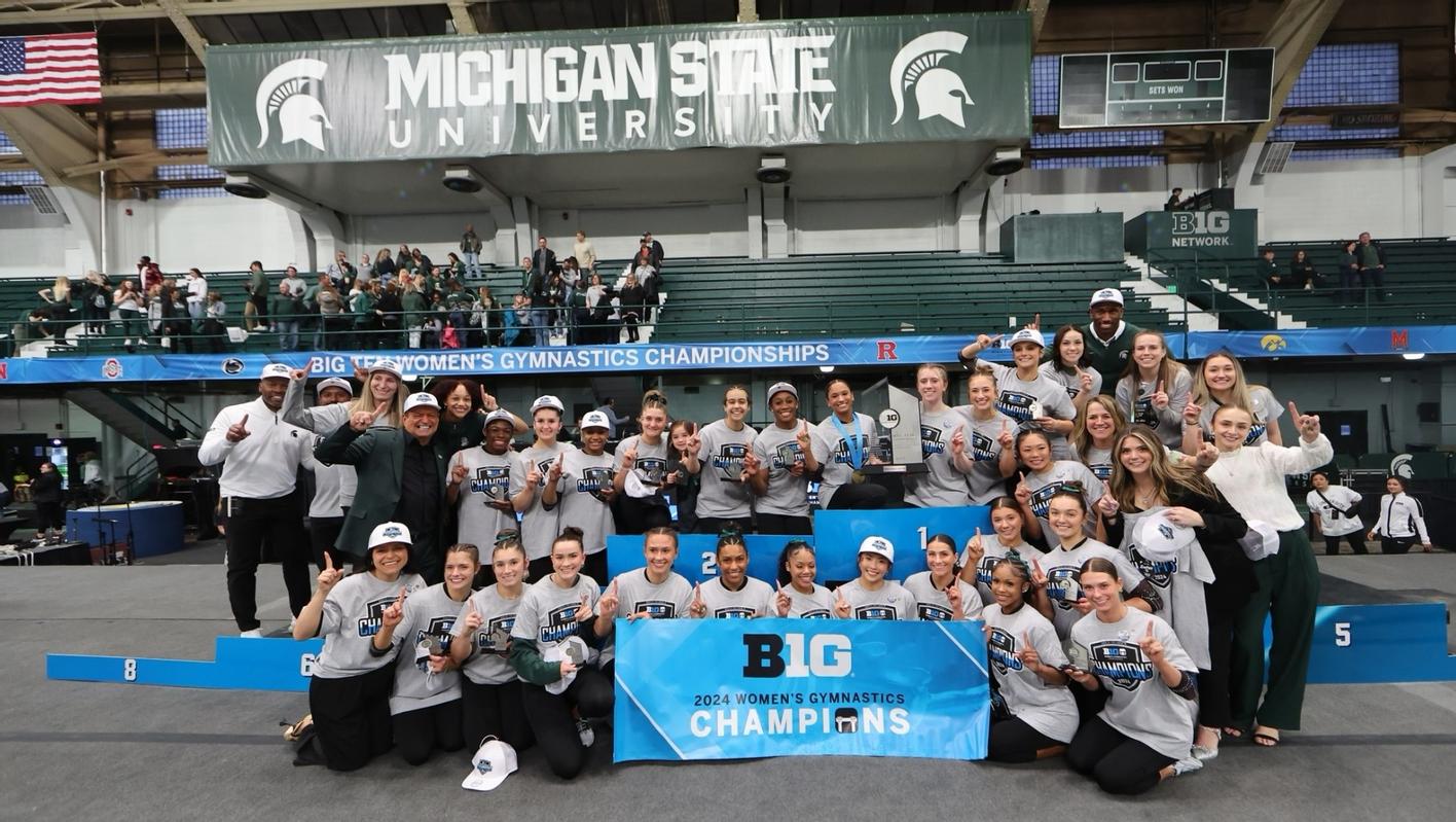The Michigan State gymnastics team celebrates winning the 2024 Big Ten Women's Gymnastics Championships.