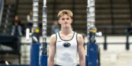 Kacper Garnczarek prepares to mount parallel bars at a Penn State men’s gymnastics meet.