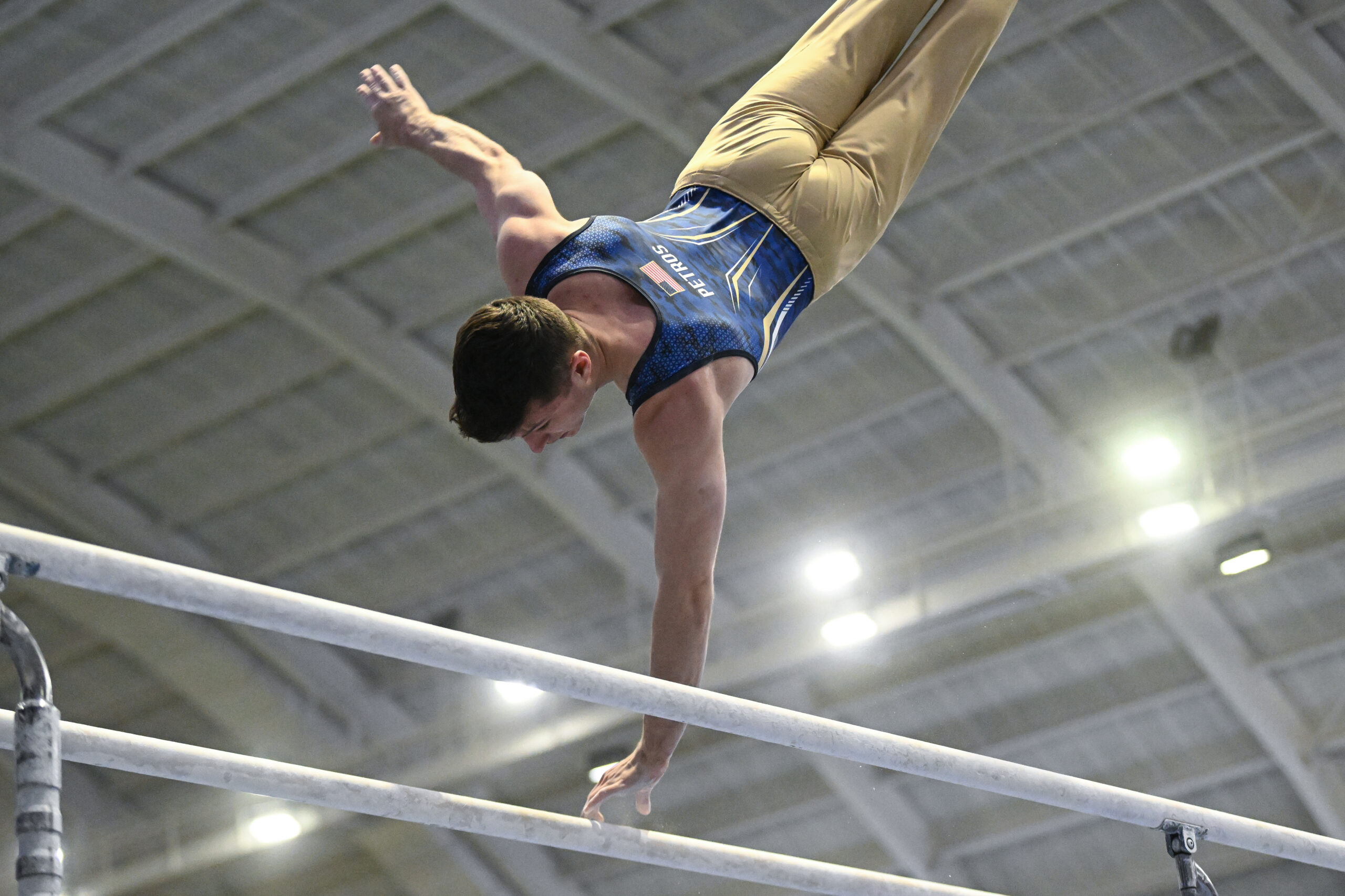 Navy's Matthew Petros on parallel bars at the 2023 Navy Open.