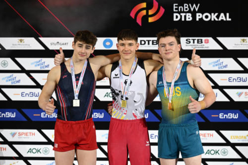 The junior men's vault podium at the 2023 DTB Pokal. From left to right: silver medalist Solen Chiodi (USA), Maxim Kovalenko (GER), and Nicholas Howard (AUS). (© Filippo Tomasi)