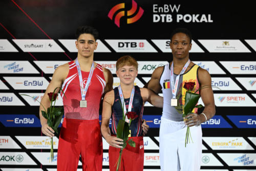 The junior men's parallel bars podium at the 2023 DTB Pokal. From left to right: Volkan Arda Hamarat (TUR), gold medalist Danila Leykin (USA), and bronze medalist Kyano Schepers (BEL). (© Filippo Tomasi)