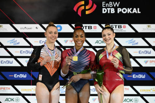 The senior women's uneven bars podium at the 2023 DTB Pokal. From left to right: silver medalist Sanna Veerman (NED), gold medalist Zoe Miller (USA), and bronze medalist Fien Enghels (BEL). (© Filippo Tomasi)